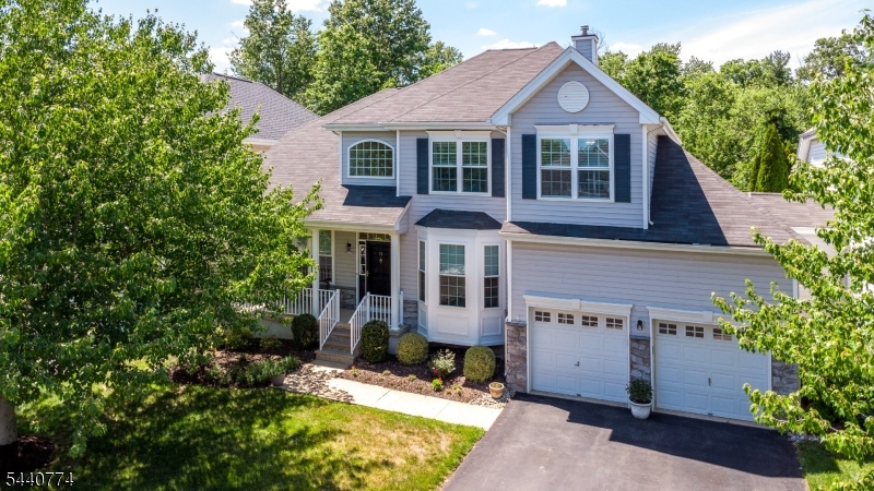 Welcome to this beautifully updated 3 bed, 3.5 bath home in the highly desirable Carriage Gate community offering style, space, and a private wooded backdrop on nearly 0.4 acres. Flooded with natural light, the open layout features hardwood floors, updated baths, and an open kitchen with granite countertops, SS appliances, large center island. The kitchen opens effortless to the Family Rm with gas fireplace and new carpet.  A formal LR and DR and laundry room complete the main floor. A seamless flow perfect for modern living. The primary en suite offers an updated bath and two walk in closets and sitting room. There are 2 additional bedrooms and bath on second floor.  Enjoy a finished full basement providing an additional 800+ sq ft of living space, closets galore, new windows in FR, LR, DR, some Bedrms, and two HVAC systems. Outdoor living shines here- the composite deck, patio, and private backyard create a serene retreat overlooking the wooded area. A charming front porch and 2 car garage finish the picture. Move in ready comfort completes this exceptional home.