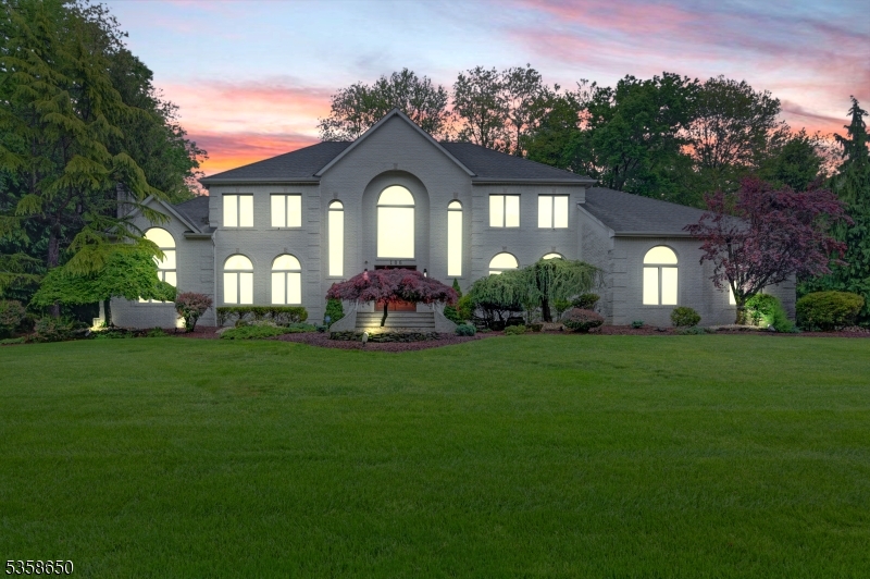 Welcome to 106 Rico Drive North, located in the heart of Marlboro, in the desirable neighborhood of Crine Woods, where elegance meets comfort in this stunning 5-bedroom, 3 FULL and 2 HALF BATH luxury home boasting a sophisticated living space. Step into a grand 2-story Foyer showcasing a multi-tiered crystal chandelier with a dramatic butterfly staircase. The Family Room with a woodburning fireplace overlooks the gorgeous pool. A Living Room creates seamless flow for gatherings. Adjacent, is a Great Room offers a custom home theatre system, built in cabinetry, and a cozy 2nd woodburning fireplace- an ideal space for gatherings or relaxing nights in. The formal Dining Room exudes elegance, perfect for hosting intimate dinners. The beautifully renovated Eat-in-Kitchen features high end appliances, sleek cabinetry and generous granite counter space- perfect for everyday living and entertaining. A rare find 1st floor 5th bedroom with its own en-suite bathroom offers privacy and convenience. Upstairs are 4 bedrooms that include a masters bedroom with enormous 210 sq ft walk-in closet and upgraded bathroom. Full finished basement adds versatile for recreation, fitness or a home office. Step outside to your private oasis: a heated In-ground gunite pool, beautifully landscaped grounds and a serene backyard ideal for entertaining or unwinding. Additional features include an oversized 3-car side entry garage. A lot of parking in the huge driveway. A MUST SEE!
