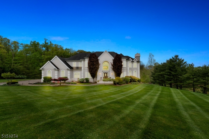 BACK ON MARKET - BUYER COULDN'T PERFORM.   Strawberry Lane is one of the most sought-after streets in Warren and, at 6000 sq. ft. on just over 2.5 acres, this spectacular home is the Grande Dame of them all.  Walk into a beautiful, two-story foyer, which leads to a home that is made to live and enjoy with your loved ones.   As you enter, you flow directly into the huge family room, with high ceilings, fireplace, and direct access to the large deck.  The eat in kitchen boasts a large island, plenty of storage, a chef's stove, butler's pantry, and access to a large laundry room.  For those special occasions, the elegant dining room with its ambient lighting and beautiful wainscotting offers the perfect setting.  An ensuite bedroom, formal living room, and office with an elegant gas fireplace, completes the first floor.   The second floor can be accessed either through the kitchen or up the elegant front staircase, the upstairs landing offers a vantage point to both the foyer and family room.   The large primary suite is as sweet as they come; fireplace, sitting area, 2 walk in closets and large master bath with soaking tub and large shower.   The 4 guest bedrooms each provide access to ensuite baths and large closet space.   The outdoor space, with a huge deck, is conveniently accessible through the kitchen and family rooms, providing that awesome indoor/outdoor feel.   The walk out basement is the entire length of the home and is ready for you to make it your dream space.
