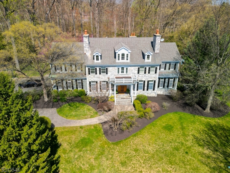 This exquisite colonial home boasts sophistication, seclusion, and serenity both indoors and outdoors. The property is stunningly situated on a 2+ acre lot within a charming neighborhood, affording majestic mountain views and a flat backyard featuring a beautiful patio and resort-style pool. Upon entry, one is immediately struck by the attention to detail that led the NJ Builders Association to award this home the title of "Best Custom Home of The Year"! The remodeled custom kitchen boasts a generous island, marble countertops, two sinks, top-of-the-line appliances, and a delightful eating area overlooking the secluded backyard. The TWO butler pantries lead into the formal dining room, making entertaining a breeze! The custom office with elegant French doors provides a delightful workspace from home. The 10-foot ceilings, three fireplaces, and hardwood floors throughout further enhance the luxurious ambiance of this home. The first-floor guest suite with full bath is a delightful bonus space! The second floor houses five bedrooms, including the primary suite with a refined sitting room and spa-like bathroom. The finished basement features daylight windows, another full bathroom, a remarkable gym, and an abundance of additional recreational space. Conveniently located close to shopping, commuter rails, and highways, and a proud part of the award-winning Basking Ridge School District!