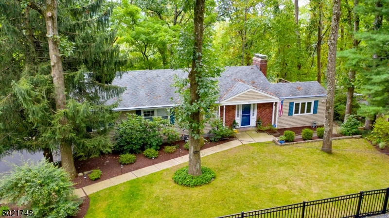 Classic Ranch with completely finished lower level! Easy living Ranch boasting formal living and dining room with lovely views of the woods, deck, 2 generous size bedrooms plus updated bath & kitchen. Windows with a view! Dining and Living Room offer wonder views to enjoy each season. Living room on first level and Family room on lower level have fireplaces with as-is condition. Updated kitchen and updated baths make this a win-win for those who want to walk in and unpack. Front of property is beautifully maintained and the rear is left natural.  Enjoy cool evenings on the deck or patio then warm yourself up by the fireplace with a good book!  The best of both worlds.