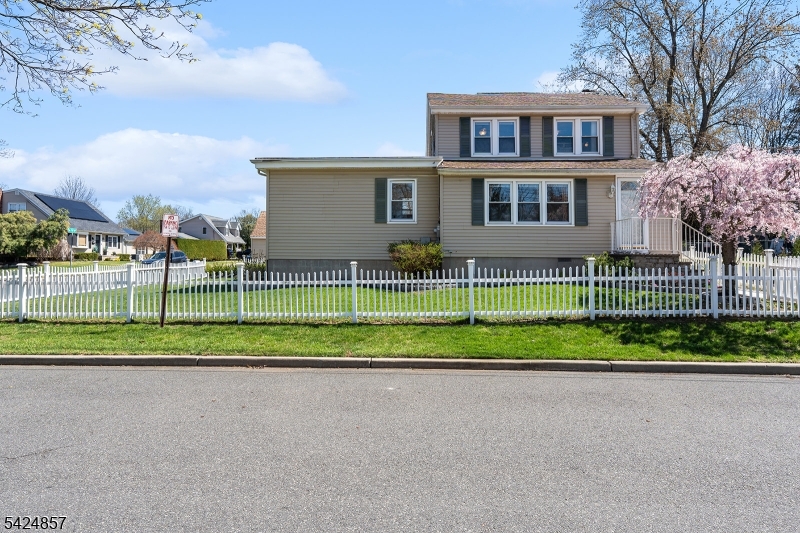 Nestled on a desirable corner lot in a quiet, neighborhood, this exceptional home is the one you've been waiting for. With 5 bedrooms and 2.5 baths, the thoughtfully designed layout provides incredible flexibility, including a potential mother/daughter suite with its own private entrance. A spacious living room with a stunning picture window, a beautiful four-season room, and a fully fenced backyard create the perfect setting for both everyday living and memorable summer gatherings. Charming landscaping and picturesque front-yard fencing add to the home's warm and inviting curb appeal.The updated kitchen is ideal for cooks of all skill levels, featuring ample counter space and light, airy finishes that enhance the natural brightness of the home. A convenient breakfast bar makes entertaining effortless, while the adjoining four-season room offers a cozy retreat for reading or gathering with loved ones. Enjoy the beauty of every season from colorful autumn leaves to spring blooms and peaceful winter snowfall all from the comfort of this versatile space.Upstairs, three additional bedrooms and a full bath are filled with natural light. Hardwood floors throughout and tastefully updated bathrooms add to the home's move-in-ready appeal. The potential mother/daughter suite includes two bedrooms, 1.5 baths, a spacious living area, and large picture windows, making it ideal for extended living or guests. This home truly offers the perfect blend of comfort, charm, and versatility.
