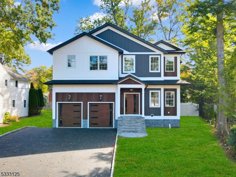 Welcome to this spectacular NEW CONSTRUCTION HOME with 7 Bedrooms and 5.5 Bathrooms boasting 4,500+/- square feet of finished living space over 3 floors located in a sought after neighborhood w close proximity to the High School, library, town pool, NYC bus stop, & shopping. Features include a two-story foyer, gorgeous hardwood flooring throughout with extensive trim and custom millwork, an open floor plan with Living Room/Dining room combo, an expansive Kitchen and Family Room with a gas fireplace and sliders to an oversized paver patio leading to the flat private yard. The kitchen is complete with high-end stainless steel appliances, large center island, quartz counters and white ceiling height Shaker style cabinetry. Convenient First-floor Bedroom, full Bath and mudroom.The Second floor has 5 Bedrooms, 3 Bathrooms and Laundry. The Master Bedroom is complete w 2 walk-in closets, spa-like bath with a soaking tub, stall shower, and dual sinks. One Bedroom is an en-suite and the other 3 Bedrooms share a spacious Full Bath.The fully finished walk-up Basement with a large Recreational Room with a built-in wet bar, Office/Bedroom and a full Bath. 10-YEAR BUILDER'S WARRANTY