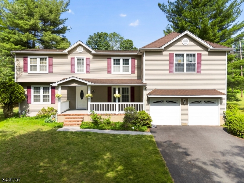 Welcome to this spacious Colonial with beautiful curb appeal, highlighted by a welcoming covered front porch and a desirable cul-de-sac location in Towaco. Set on a large property with a generous backyard, this home offers abundant living space and a convenient location near Lake Valhalla Club, parks, shopping, and transportation. The kitchen was renovated approximately 12 years ago and showcases rich cherry cabinetry, granite countertops, a decorative tile backsplash, a peninsula, and abundant storage. Hardwood floors extend throughout the first floor, enhancing the home's inviting feel. The main floor also includes a welcoming entryway, formal dining room, family room, and living room with front to back windows. The second level includes a substantial addition and offers an impressive layout with five bedrooms plus a versatile bonus room with a washer and dryer, providing flexible space for a variety of needs. The unfinished basement offers storage and future possibilities. The home is currently serviced by well water, with the option to connect to town water. Public sewer and gas heat. Located within Montville's highly regarded school district and just minutes from the train station, major highways, restaurants, shopping, and recreational amenities, this home presents an excellent opportunity to enjoy space, convenience, and a sought-after Towaco setting.