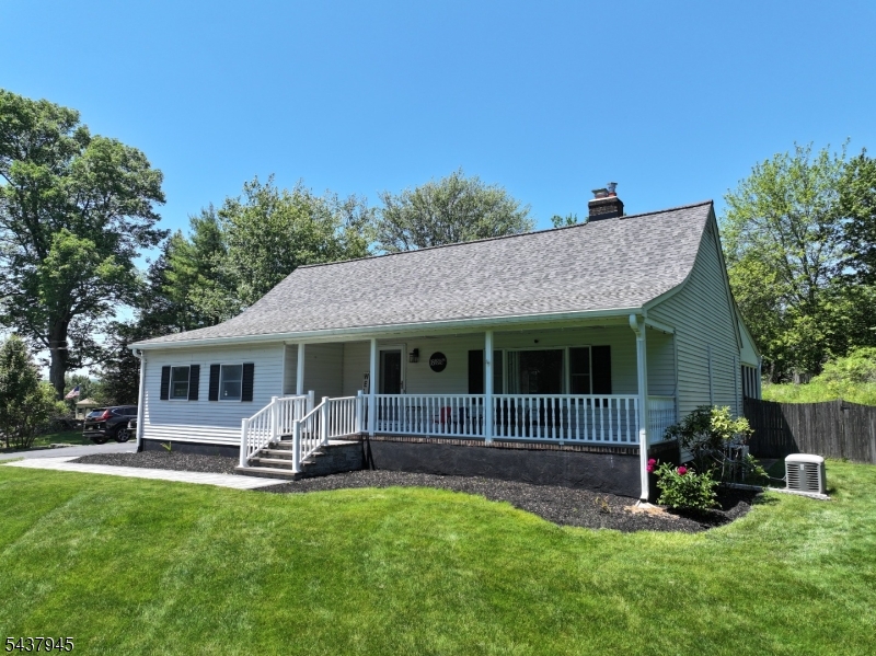 Welcome to this custom Cape Cod-style home set on 1.7 picturesque, park-like acres offering privacy, comfort & exceptional living space. Lemonade front porch welcomes you to this 4-BR, 2-bath residence featuring desirable 1st-floor primary BR & beautifully updated baths w/ tile finishes & tub/shower combinations. Updated kitchen equipped w/ granite & SS appliances flows seamlessly into dining area & living spaces. DR & LR are warmed by stunning 2-sided gas FP while impressive 25' x 17' LR boasts soaring 2-story ceilings, abundant natural light. Open 2nd-floor hallway overlooks LR below, enhancing the home's spacious feel. Upstairs you'll find three additional bedrooms, dedicated storage room & versatile flex space ideal for playroom, hobby area, expanded storage, or even relocation of washer & dryer. Vinyl plank flooring extends throughout the home for cohesive & low-maintenance finish. Enjoy year-round comfort w/ 2 main-level mini-split systems & peace of mind w/ whole-house generator. New roof in 2024, natural gas boiler installed in 2025, public sewer service & two-car attached garage w/ automatic openers add to the home's convenience & efficiency. Relax in inviting 3-season sunroom w/ access to 14' x 13' deck overlooking a fabulous private backyard oasis perfect for entertaining, outdoor gatherings, or simply enjoying the tranquil surroundings. Unique property combines modern updates, flexible living space & exceptional setting to create truly special place to call home.