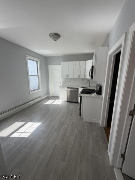 Beautifully renovated 2nd-floor apartment featuring 3 spacious bedrooms and 1 full bathroom. This move-in-ready unit offers modern finishes throughout, providing a comfortable and stylish living space. All utilities are included for added convenience. Conveniently located just 15 minutes from Jersey Gardens Mall, with easy access to shopping, dining, and transportation. Small dogs are welcome.