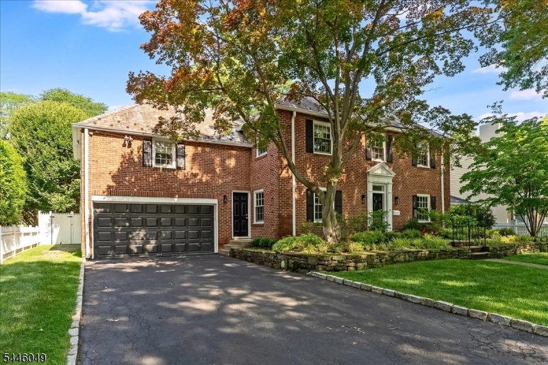 Sitting on a desirable, tree lined cul-de-sac in Upper Montclair's Fieldstone enclave, this impressive 1937 Georgian Colonial is the combination of natural beauty & architectural history. The brick front center hall residence borders the Bonsal Wildlife Preserve & is close to Mills Reservation & Presby Iris Gardens. Ten rooms w/ endless uses provide sumptuous space for home life & all kinds of gatherings. Upon entry, the gracious living room w/ fireplace, which sits opposite the formal dining room, flows into a family room right outside the fully equipped kitchen. Quietly adjacent to the eat-in kitchen & up a short stairway is a private bedroom & en suite bath. The driveway entrance leads to a small mudroom off the dining room. A powder room completes the first floor space. Step out the family room doors into the backyard w/ its lush saltwater pool replete w/ waterfalls (no need to chase them), a hot tub & a large deck & patio. Pool lighting & the natural rock ledge diving platform make the yard feel like a vacation stay instead of home. Follow the graceful wooden banister up the staircase to the second floor where you'll find the primary bedroom & en suite bath along w/ three additional bedrooms & hall bathroom. Access to the basement is from the kitchen stairs where two large rooms, laundry & plenty of storage space await you. The home has central air,  oversized 2 car garage & driveway to fit four cars. Nearby are shops, restaurants, schools & NYC transportation.