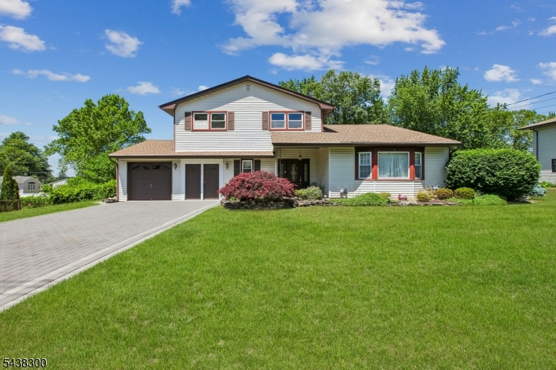 Welcome to Sayrewood South! This well-maintained split-level home offers outstanding curb appeal and plenty of room to grow. Situated on an oversized 100x150 lot, the home features a brick paver driveway, mature landscaping, and a large fenced backyard perfect for entertaining, play, pets, or simply relaxing outdoors. The entry level includes a comfortable family room, convenient half bath, and direct access to the two-car garage, paver patio, and backyard. Upstairs, you'll find bright and inviting living spaces, with hardwood floors beneath the carpeting ready to be revealed. Major updates include a 7-year-young roof and HVAC system, offering peace of mind for years to come. Lovingly maintained by its owners, this move-in-ready home presents a wonderful opportunity in one of Old Bridge's most desirable neighborhoods. Don't miss your chance to make this Sayrewood South gem your own!