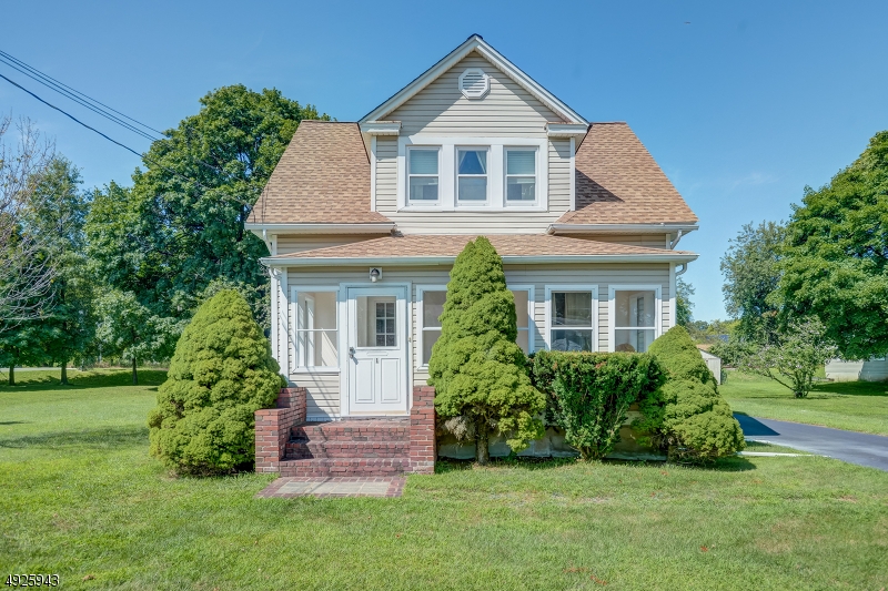 Updated home with original charm features front porch, living room, dining room, kitchen, bath and mudroom on first floor; 3 bedrooms and bath on second, finished basement and oversized garage. The inviting front porch of this updated colonial welcomes you inside where you find a living room entry flanked by custom, handmade built-in bookcases. This lead to the dining room and in to the open kitchen with updated cabinets, back splash, counter tops, appliances and tile floor. Off the kitchen is a new full bath and a mud room which leads to the back deck. The second floor offers 3 bedrooms and a second full bath. There are hardwood floors throughout the home. The oversized garage has plenty of room for vehicles and a large workshop. The home sits on a large, flat corner lot, with mature trees.