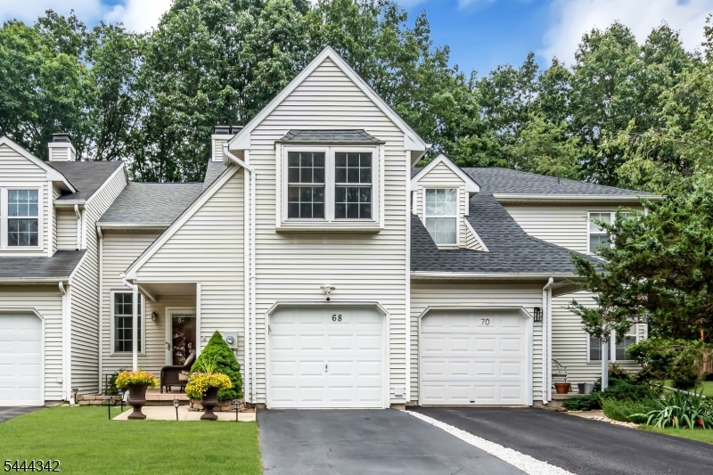 Welcome to 68 Delaware Lane in desirable Winding Ridge! This beautifully maintained 3-bedroom, 2.5-bath townhome offers spacious living, tasteful updates, and a private setting backing to peaceful wooded common grounds. A dramatic two-story foyer opens to a bright floor plan with generous living and dining areas. The updated kitchen features granite countertops, custom cabinetry with built-in pantry, stainless steel appliances, ceramic tile backsplash, breakfast bar, and ample workspace. Hardwood floors throughout the second level and bedrooms, along with renovated bathrooms, add timeless appeal. The spacious primary suite includes ample closet space and an updated en-suite bath. Two additional bedrooms offer flexibility for guests, or a home office. A finished basement provides extra living and storage space. Relax on the oversized deck overlooking wooded common grounds. Additional highlights include an attached garage, newer roof, updated garage door, and numerous quality improvements. Conveniently located near major highways, shopping, dining, parks, and top-rated Branchburg schools, this move-in-ready home offers low-maintenance living in one of Somerset County's most desirable townhouse communities.