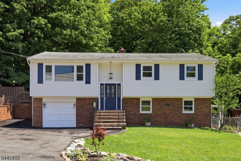 Move right into this Beautifully Updated 4-bedroom Bi-Level that's ready for its new Owners! With Fresh Updates throughout, all that's left to do is unpack your bags and start enjoying your New Home. The main level features a Newly Renovated Kitchen with direct access to the back deck from the Kitchen/ Dining area, making indoor and outdoor entertaining effortless. Refinished Hardwood Floors and Fresh Paint throughout create a bright, Welcoming Atmosphere. The primary suite includes an updated private full bath with a beautifully renovated shower. The ground level offers additional living space with a spacious family room, fourth bedroom, and convenient interior access to the garage, providing flexibility for guests or a home office. Step outside to your own private backyard oasis featuring peaceful surroundings, a garden area, and plenty of space to relax or entertain. Extra parking is perfect for your BOAt, RV, trailer, extra off road parking. Located just minutes from Lake Hopatcong, you'll enjoy the very best of lake living from BOAting, swimming, fishing, and waterfront dining in the summer to year-round recreation, including snowmobiling during the winter months. If you've been searching for a Move-In Ready Home at an Exceptional Value, this is your opportunity. Start living the Lake Lifestyle you've always dreamed of! Public Water, Public Sewer.