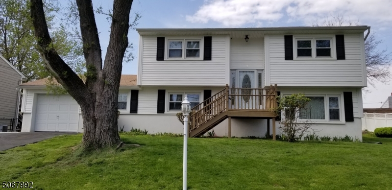 Unique layout with this 4 bedroom Colonial style home. When entering this home you will be greated with a bi-level type staircase. You can choose to venture downstairs, to the living area consisting of a Den or Family room (your choice), Dining room, Living room, eat in Kitchen with Laundry/Utility room off the kitchen. There is a convenient door in the garage that leads into the den, a sliding glass door leads to the backyard patio and there is a door in the Laundry/Utility room that leads outdoors as well. The upper level boasts of 4 nice sized bedrooms with hardwood flooring under the carpet. Square footage of 1916 is approximate and taken from the NJACTB Site. During the late fall to early spring months you can enjoy breathtaking views of Lake Hopatcong from atop this peaceful mountain setting.
