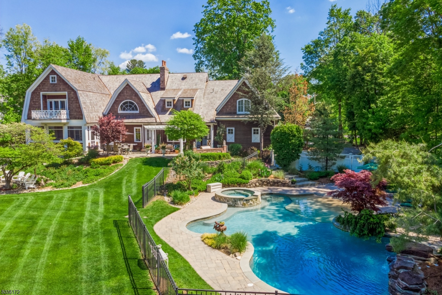 Stunning Hampton Style 1.7 acre estate featuring 5 bedrooms,4 full and 2 half baths. Exquisite parklike property with Masterson Gunite pool and stone patios perfect for outdoor entertaining. Upon entering into the 13 room treasure you will be immediately wowed.The great room stuns w/ exceptional millwork,valulted ceiling and grand stone fireplace that separate a billiard room on the other side.The kitchen seamlessly unfolds in the open floor plan. Custom cabinetry adorns this perfect kitchen w/top of the line appliances and new quartz counter tops.Upstairs the master bedroom suite offers ample closets and elegant spa-like bath complete w/steam shower and soaking tub.3 additional bedrooms and ensuite w/ seperate staircase and gym area.Basement has cozy bar room,family room and turfed area.
