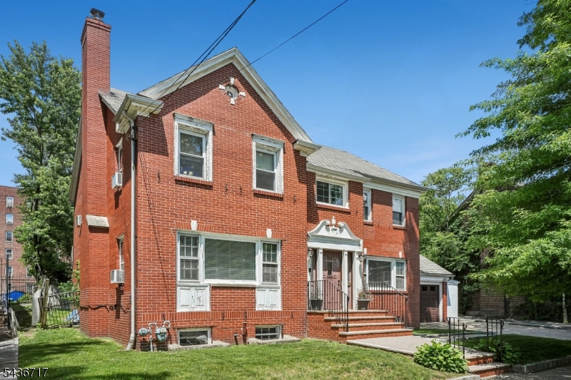 Welcome to this Classic Center Hall Colonial home rich in timeless character, architectural charm, and incredible potential. Located in Newark's desirable architectural Details, and enduring character. This home offers convenient access to Weequahic Park, schools, major highways, public transportation, and Weequahic Park section, this spacious home offers six bedrooms, four full baths, one half bath, and the craftsmanship rarely found in today's homes. As you enter, you are welcomed by a grand foyer with a stunning curved staircase, hardwood floors, crown moldings, arched entryways, and abundant natural light that showcase the home's original beauty. The kitchen features granite countertops, stainless steel appliances, and a center island that's perfect for your morning coffee or get togethers. The spacious living room is filled with natural light and features a wood-burning fireplace that adds warmth and charm to the home. The second floor offers four generously sized bedrooms, including a primary suite, while the finished third level provides two additional bedrooms and a full bath, offering flexible space. This home includes a two-car garage and a paver driveway that enhances the property's curb appeal. While the property requires repairs and updating, it presents a unique opportunity to restore and customize a home with exceptional space, classic easy commuting options to New York City.