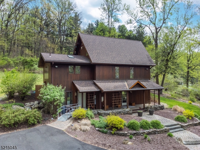 Gorgeous Lindal Cedar Home with walls of windows giving natural light and privacy on 20+ acres! 8+ acres in White Twp. and 12+ acres in Liberty Twp.  Ground level includes massive mud room/laundry room, family room with beamed ceiling, two spacious bedrooms and full bath.  2nd floor offers open floor plan with floating staircase between living and dining rooms, high ceilings, updated center island eat-in kitchen and primary suite with walk-in closet, full bath with stall shower, skylight and bedroom has sliders to deck.  Loft on 3rd floor.  Hardwood flooring on 2nd and 3rd floors, new carpeting on ground floor and primary suite, new roof in 2019 and driveway repaved in 2020. Incredible character, like living in a tree house!  Woodland managed by local forester and logger.  Property in both White Twp and Liberty Twp; 3 lots:  12.43+7.16+1.0 = 20.59.