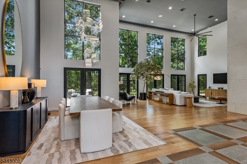 Completed in 2019, this extraordinary modern residence combines distinctive architecture, exceptional craftsmanship, and resort-inspired amenities on a beautiful 3-acre setting. Thoughtfully designed landscaping, stone retaining walls and walkways frame the courtyard. The dramatic glass entry and floating staircase provide an architectural focal point. A stunning two-story great room and dining room serve as the centerpiece of the home, where soaring ceilings, walls of glass, and natural light create a sense of openness. The incredible chef's kitchen is a showcase of design and functionality, featuring European cabinetry and Miele appliances. The first-level primary suite is a luxurious sanctuary complete with a dressing room, sumptuous bathroom, and access to the rear patio. Four additional en-suite bedrooms occupy the 2nd level, complemented by an open sitting area, laundry and a large Azek deck. One suite offers flexibility as a 2nd primary, media room, or fitness space.An expansive stone patio connects seamlessly to the covered entertainment room, complete with fireplace and built-in grill. The saltwater pool is surrounded by beautiful landscaping. A heated three-car garage, irrigation system and generator further distinguish this exceptional residence.This coveted location is close to top schools, shopping, dining, and recreation opportunities, as well as equestrian facilities and nationally ranked golf courses. Convenient access to highways and NJ Transit to NYC.