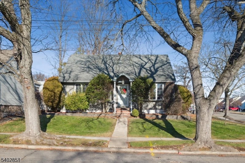 Set on a sunny corner lot along a quiet residential street, this Cape Cod home offers a wonderful opportunity in the heart of Bloomfield. With a classic layout, hardwood floors, and generous space, this home is ideal for buyers looking to add their own personal touch in a prime location.The main level welcomes you with a spacious living room filled with natural light from charming bay window, flowing into the dining area and kitchen. Two bedrooms including a first-floor primary bedroom and a full bathroom complete this level. A small porch leads directly to the fenced backyard, offering a great canvas for outdoor living, while the attached one-car garage adds everyday convenience.Upstairs, two large bedrooms provide flexible space for future bedrooms, a home office, or creative use. Hardwood floors throughout the main and second floors add warmth and character and ready to be refreshed.The full basement is partially finished with a wood bar and corner bench, along with a laundry area and an additional toilet with sink. With vision and updates, this level can be transformed into an amazing recreation room, workspace, or extended living area.  Just minutes to NYC transportation, Bloomfield train stations, major highways, parks, shops, and dining this  solid home offers great bones, space, and an unbeatable setting.