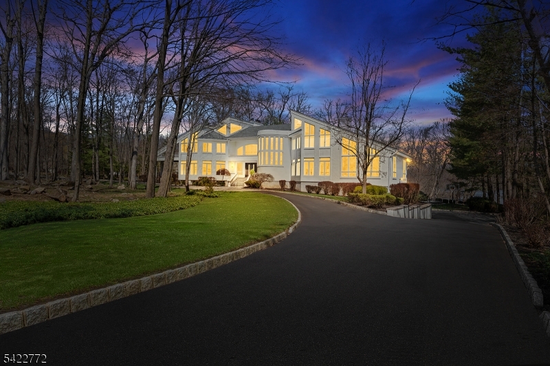 Wake up each day to breathtaking lakefront views in this striking modern home, set within the gated Smoke Rise community on one of its most coveted streets. Defined by walls of glass & clean architectural lines, the home is designed to maximize natural light, privacy, & a seamless connection to the landscape. Live and entertain with ease as the home offers: a dramatic great room with soaring ceilings and expansive windows, multiple living and gathering spaces, a chef's kitchen with high-end finishes, and a seamless flow to the rear deck overlooking the water. The lower level is designed for entertaining, featuring a custom theater, recreation space, wet bar, fitness area, & walkout access to the backyard. Outdoors, the setting has been curated with a newly installed pool, sunken fire pit overlooking the lake, and extensive hardscape, landscaping, and integrated audio, creating a private resort-like experience. Upstairs, spacious bedrooms and a stunning primary suite provide comfort and privacy, while thoughtful design and quality finishes carry throughout. The setting, lakefront lifestyle, and level of finish truly make this home one of a kind. Within this sought-after gated enclave, you'll find one of New Jersey's liveliest social scenes, with an array of clubs, dining, a beach, tennis club, sports bar, fishing, swimming, 24/7 gated security, & more. Embrace this exceptional opportunity to own a breathtaking home in an unparalleled setting. Schedule your private tour today.