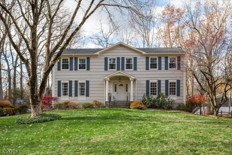 Classic Colonial set on a beautiful 0.52-acre lot in a peaceful cul-de-sac, offering the perfect blend of comfort, space, and an unmatched location. This inviting home features 4 bed, 2.5 baths, and a 2-car attached garage, providing all the essentials for everyday living. Step inside to a welcoming foyer with tile flooring that leads into a bright formal living room and an elegant dining room. The eat-in kitchen offers generous workspace and cabinetry, opening seamlessly to the inviting family room with a wood-burning fireplace. Sliding doors extend your living space to a large deck overlooking the serene backyard, perfect for relaxing or entertaining. A convenient powder room and laundry room complete this level. Upstairs, the expansive primary bedroom offers a private bath, a dressing area, and a WIC. Three additional spacious bedrooms and a full hall bathroom on this level. The partially finished basement provides flexible space for a rec-room, home gym or office, along with ample storage. Additional highlights include hardwood floors throughout, Roof 2021, Furnace/AC 2022, all New Windows in 2nd Level, Exterior painting 2025.  Truly an exceptional location blocks from Patriots' Path, NJ Transit train direct service to NYC, the Frelinghuysen Arboretum, and vibrant Downtown Morristown with its restaurants, shops, and arts scene. Enjoy the convenience of Morris Plains living while tucked away in a quiet, tree-lined setting. A wonderful opportunity to make this home yours.