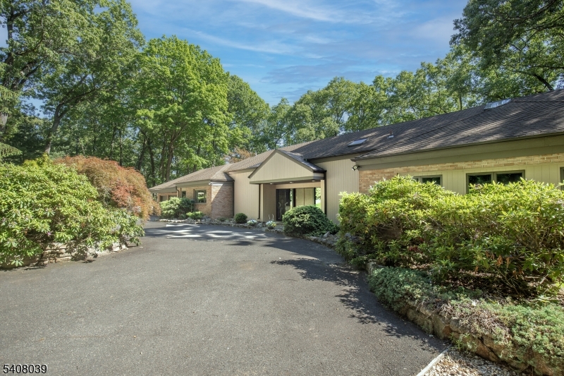 Extraordinary custom home with stunning long countryside views to the south.  Sophisticated country living yet convenient to Morristown, public and private schools, golf courses, equestrian facilities, public transportation, The Mall at Short Hills, fine dining, Newark Liberty International Airport, Jockey Hollow National Park, the New Jersey Audubon Society park and more.  The primary residence features a Living Room anchored by a wood-burning fireplace, Dining Room, paneled Library with fireplace, open-plan kitchen/sun room, luxurious primary suite with cathedral ceiling, two custom walk-in closets and a spa-like bathroom.  Two additional bedrooms and bathrooms and two powder rooms complete this level. The lower level includes a recreation room, three bedrooms, two bathrooms and storage and utility rooms. There is a three-car attached garage. The blue stone terrace invites outdoor dining and relation. A pool and tennis court provide exercise and relaxation too. Flowering trees and shrubs and perennials highlight the grounds. Solar panels provide electricity. The Carriage House, situated on a separate lot, has three bedrooms, living room with cathedral ceiling and a finished walk-out lower level. The deck provides long countryside views.
