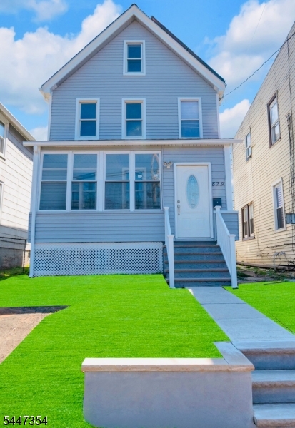 Impeccably Remodeled 3-Bed Colonial! Welcome to this beautifully renovated Plainfield gem, freshly repositioned to attract today's prospective buyers. This stunning 3-bedroom, 1.5-bath Colonial has been thoughtfully updated from top to bottom while maintaining its classic charm. The inviting enclosed front porch leads into a bright, airy living room featuring a stylish pass-through window into the spacious eat-in kitchen perfect for entertaining. The kitchen is finished with warm oak cabinetry, crisp subway tile backsplash, quartz countertops, stainless steel appliances, pendant lighting, and a large pantry. Upstairs you'll find two generously sized bedrooms with abundant natural light and an updated full bath with a glass-enclosed shower. The third-floor bedroom offers vaulted ceilings and great versatility. Outdoor living shines with an enclosed year-round porch, expansive rear deck, and fully fenced backyard. The full basement provides excellent storage and laundry. Bonus: fully owned solar panels for energy savings! Located on a quiet street and move-in ready schedule your showing today!