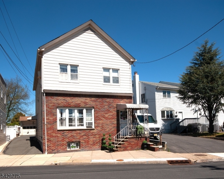 Excellent investment opportunity!  Two-Family home with half brick front, long driveway & oversized detached two-car garage.    An ideal setup offering two bedrooms in each apartment with separate utilities and entrances to an unfinished basement with washer/dryer hookups.    1st floor has high ceilings, spacious living room, renovated bathroom, updated kitchen with built-in cabinetry highlighted by a decorative tin ceiling.  2nd floor has a modern kitchen with granite countertops, stainless steel appliances and sizable living room/dining room filled with natural light.  Very close to shops, restaurants, parks, schools (Blue Ribbon district) & transportation (one mile to train station), bus around the corner.   Reasonable Property Tax.  Occupy one unit while earning rental income from the other!