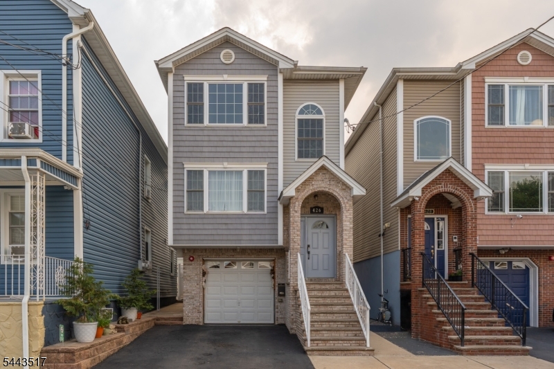 This stunning two-family home offers spacious living on each level, featuring three bedrooms and two full bathrooms upstairs and downstairs with beautiful hardwood floors throughout the home. It also has a finished ground level apartment that adds a valuable bonus living space & convenience to the property. Just minutes from Newark Airport and only about 35 minutes to NYC, this home is perfect for both living and entertaining. Enjoy summer days by the above-ground pool and relax under the backyard gazebo. Don't miss this fantastic opportunity!