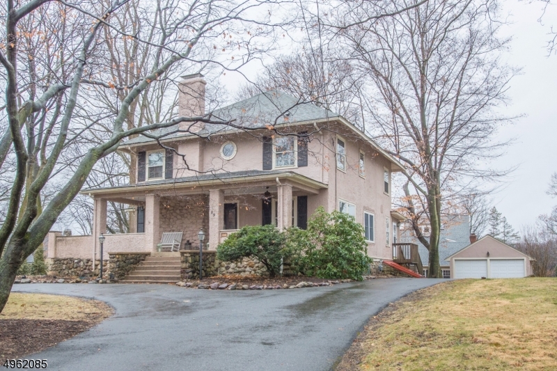 HISTORIC COLONIAL! Rare value in the center of desirable lake community on quiet street in prestigious Mtn Lakes. Grand house w/unique architectural features. Charming, wrap around porch. Uniquely designed in the true 4-square style. This Hapgood offers 3 Floors of roomy, spacious living featuring rich, intricate woodwork, large entryways, HW floors & more.. which all blend perfectly w/modern updates. A renovated kitchen includes cherry cabinets, granite countertops, center island & bfast area. Formal dining w/wainscoting & plate rail opens to large LR w/oversized WB fireplace. A house fit for your dinner party! Upstairs offers 4 bdrms including a mstr suite. BONUS entertaining in full, finished bsmt. Tons of big upgrades - CA, newer furnace, water heater, etc. Circular Driveway +2 Car Garage.