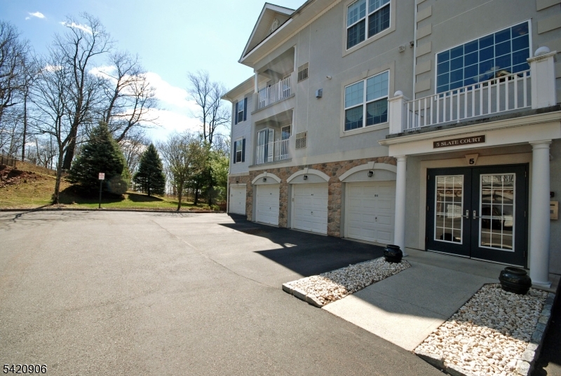 Top floor BEGONIA in a superb location with fantastic views!    Enjoy resort style living in this prestigious 55+ gated community.   An ideal floor plan with an open feel offering privacy between the bedrooms.  A bright kitchen with white cabinetry, ample counter space, breakfast nook & pantry.  Primary bedroom suite has an accented tray ceiling; large walk-in closet & luxurious bathroom filled with natural light.  Featuring newer HVAC, furnace & hot water heater, plantation shutters and private garage w/storage room.  Take in the beauty of nature, colorful trees, a slice of the NYC skyline & sunrise from your balcony and windows.  An outstanding 25,000 sq ft clubhouse with the BEST amenities: indoor & outdoor pool, tennis/pickleball, card rooms, Mahjong, putting/driving, fitness center, grand ballroom, clubs, activities & more.    Bordering Montclair with terrific restaurants, shops & boutiques.   Experience the joy of a carefree & comfortable lifestyle in a peaceful setting!