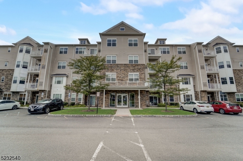 Great central location! Easy access to highways. VERY close to both Rutgers main campus and RWJ Med Center.  Cedar Wood is a very desirable community 7 min from   NYC direct train station in Dunellen.  The condo is in a secure building with intercom system, and easy elevator access to the 4th floor. Head down the wide hallway to the corner unit where you enter into the formal foyer which opens to light, airy single floor living of over 1500 sq ft of living space.  The contemporary kitchen has granite counters with a breakfast bar, stainless-steel appliances and is open to large dining room which is adjacent to the living room. The terrace off the dining room is perfect for al fresco meals.  Dark stained hardwood floors in the living areas, hallway and office maintain that chic modern look.  The primary bedroom has large ensuite bathroom with a double vanity, large stall shower, and a deep "walk-in" closet.  Large 2nd bedroom has large closets and modern ceiling fan.  The in-unit laundry room also has lots of storage. This condo comes with one garage space and is also assigned a large separate storage room both accessed through the lobby on the main floor.  The HOA fees cover the fantastic luxury lifestyle of the lounge, meeting rooms, and fitness facilities in the business center. The grounds are meticulously maintained as is the lovely playground. School bus stop at the complex. Brand NEW central AC installed 7/27. Lender has been found who will finance!!!