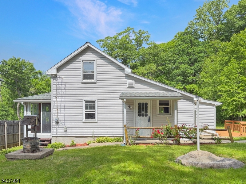 Welcome to 196 Rockport Rd. A refreshed and move-in ready custom home set on nearly 3/4 of an acre in scenic Port Murray! This charming property offers a comfortable blend of indoor and outdoor living with thoughtful updates throughout. Inside, you'll find fresh neutral paint, brand new vinyl flooring, stainless steel appliances, 2 bedrooms, 1 full bath, plus a flexible bonus room perfect for a home office, creative space, workout room, or additional storage needs. Enjoy morning coffee year-round in the enclosed front porch or spend evenings entertaining on the oversized rear deck overlooking the beautiful park-like backyard. The expansive outdoor space offers endless possibilities for gardening, recreation, entertaining, or simply relaxing in a peaceful setting.Need extra room for hobbies, storage, equipment, or workspace? Multiple sheds and garage/storage buildings provide excellent versatility, while the circular driveway offers abundant parking and convenience. A brand-new septic system will be installed prior to closing for added peace of mind. Conveniently located near Hackettstown shopping, dining, breweries, parks, and commuter routes, this property combines country-style surroundings with nearby everyday conveniences. A wonderful opportunity to enjoy refreshed, move-in ready living with space both inside and out!