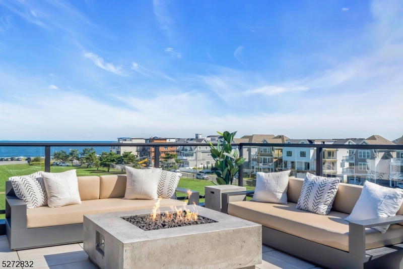 Home Eleven at The Reef is a true turn key experience & includes the full RH furnishing package, many builder upgrades, window treatments, professionally selected linens & decor throughout. This home is fully ready to be your Summer 2024 beach home! Discover the pinnacle of seaside elegance in this exquisite brand new 5 bedroom, 5 bathroom ocean view townhome nestled in the heart of the beautiful seaside community of Long Branch. The Reef offers the very best of luxurious living with a host of extraordinary features that make it a dream coastal destination. Each residence was meticulously constructed by a renowned local Custom Home Builder with attention to detail and a perfect blend of beautiful design, luxury finishes, & quality craftsmanship. As you enter your home you are greeted by the convenience of a private four-stop elevator. The rooftop deck is nothing short of spectacular, complete with a cozy fire pit and an outdoor kitchen. Here, you can savor sunsets, entertain guests, or simply unwind while soaking in the breathtaking views of the oceanfront. At The Reef, luxury & coastal living merge seamlessly. Two beautiful Gunite Pools, a well-equipped gym & community center are all at your disposal with none of the maintenance! All of this located a short distance from beaches, boardwalk, dining & entertainment at the heart of the Jersey Shore! Don't miss your chance to experience this unparalleled blend of comfort and style. Your Shore Lifestyle is calling!