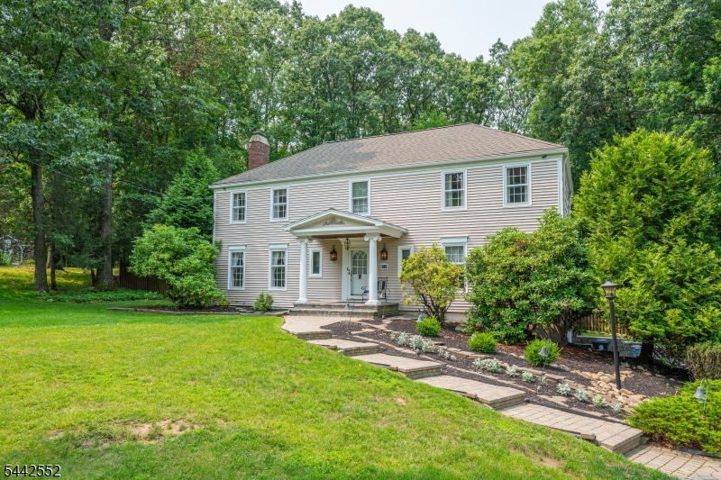 Gracefully set on 1.67 acres at the crest of a cul-de-sac in the Trailwood area of Hanover Twp, this 4 BR, 2.5 BA Colonial was built by the renowned Harvey Caplan. Enter from the impressive front porch to find HW floors, crown molding, a formal LR with fireplace, a formal DR, and a granite/stainless kitchen with custom cabinetry and a passive solar dining area featuring extensive glass and a custom granite table. A family room, powder rm, and laundry rm complete this level. Upstairs find a spacious primary suite with walk-in plus double closets, laundry chute, a full BA and dressing area with custom maple cabinetry, marble tops, garden window, and frameless shower door plus 3 more BRs (2 with walk-ins), and a full BA with upgraded cabinetry, granite tops, tub/shower, and porcelain walls. Basement level: recroom, den, wkshop, tons of storage, 2car garage with storage room. A wrap-around deck with awnings and garden sink overlooks a level, fenced backyard paradise complete with perennial gardens and cabana shed. This property offers endless possibilities for creating your own private retreat to make your dreams come alive! Extras: 8 zone sprinkler system, sec system, 200amp service, wired w/speakers in den, LR, kitchen, deck. HVAC 9/2022. This is an outstanding home in Hanover Township known for its low taxes, great schools and town services, and proximity to shopping, restaurants, vibrant downtown Morristown, recreation, major hwys, and NYC trans incl Mid-town Direct stations!