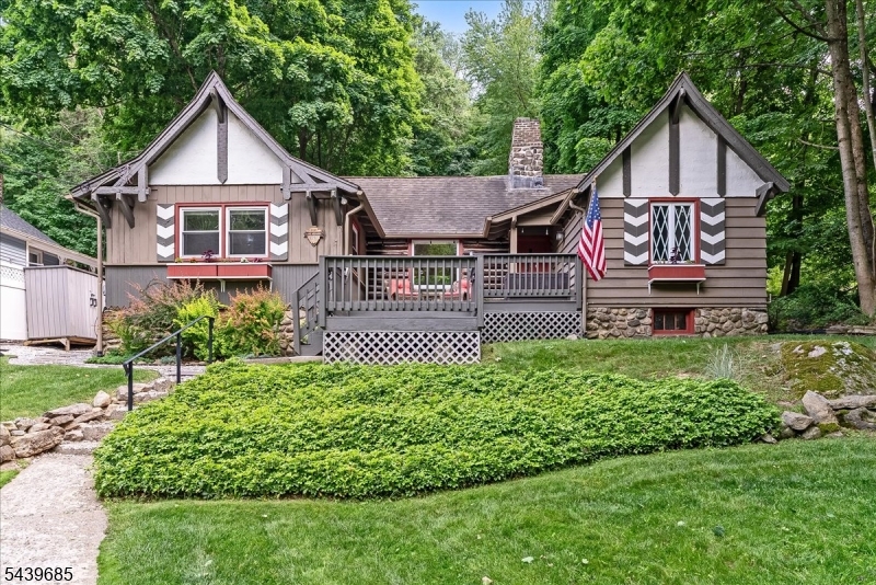 Experience the laid-back Lake Mohawk lifestyle in this charming 3-bedroom, 2-bath home filled with character, natural light, seasonal lake views and a private backyard oasis! High ceilings and hardwood floors create an open, airy feel, while large windows bring the outdoors in and fill the home with sunshine throughout the day! The well-appointed kitchen features granite countertops, stainless steel appliances, and plenty of space for cooking, gathering, and entertaining.  Step outside to your own private backyard retreat. Surrounded by nature, this incredible outdoor space features a beautiful fountain, rustic herringbone brick patio and plenty of room to relax, dine al fresco, or unwind after a day on the lake. Perfectly situated within the Lake Mohawk community, this home enjoys an exceptional location between Beach 5 and Beach 6, making it easy to enjoy swimming, kayaking, lakeside relaxation, and all the recreational amenities that make Lake Mohawk so desirable. This home offers a wonderful opportunity to enjoy the best of lake community living in one of the area's most sought-after settings. Don't miss the large basement which is ideal for storing all your lake toys!