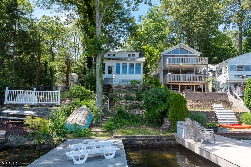 Charming cottage on beautiful Lake Hopatcong. Large living area with beamed ceilings and views galore. Watch the sunrise from the house, patio, or dock. Open living space with hardwood floors throughout. Newer appliances, new roof, new well pump, updated water softener, newer water heater, insulated, recently paved driveway , parking for 4 cars and a couple of boats. Loft on 2nd floor could make a great reading nook or office space.Enclosed porch in front. Close to major highways, mass transit and just an hour from NYC. Come see what lake life is all about this summer on New Jersey's largest lake!