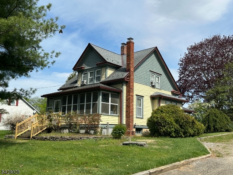Discover the charm of this vintage-style Cape Cod, offering a unique opportunity to embrace a sustainable, self-sufficient lifestyle. Featuring a brand-new 3-bedroom septic system, this home blends character with peace of mind. The main level welcomes you with a spacious foyer accented by original woodwork and sliding pocket doors that seamlessly connect the living and dining areas. A versatile family room addition, complete with a kitchenette hook-up and an adjacent full bath, offers excellent potential for a private mother-daughter suite or guest quarters.The expansive grounds are a true highlight, bordering protected public open space and park facilities. Gardening enthusiasts will appreciate the 12x14 shed with an attached greenhouse frame, providing the perfect foundation for year-round cultivation of your own fruits and vegetables. With additional outbuildings, including a 15x30 roofed structure, the property is perfectly suited for a hobby farm, including space for a chicken coop.Beyond the home, enjoy the covered front porch or take advantage of the generous lot size, which easily accommodates a home-based business, workshop, or storage for trucks and equipment. Complete with a detached garage and carport, this property offers endless possibilities for those seeking a unique, productive, and flexible living environment.