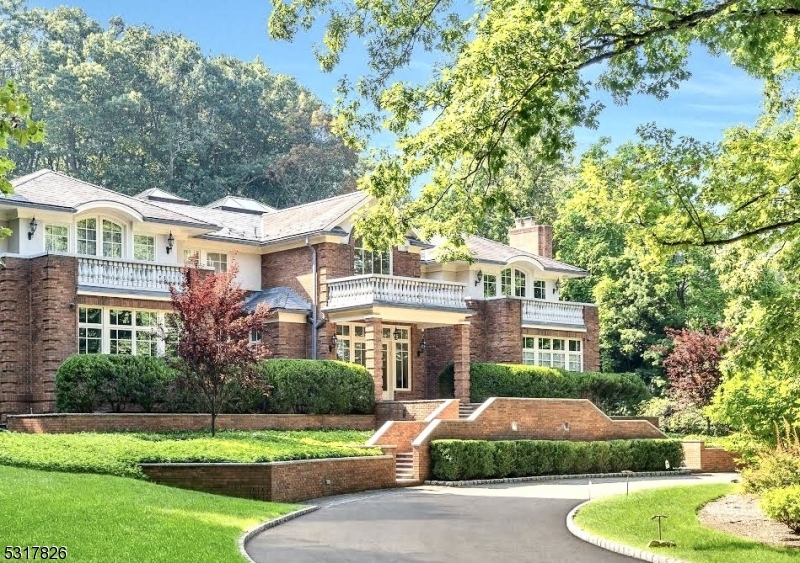 Welcome to 253 Hartshorn Drive, a luxurious sanctuary set in the prestigious Hartshorn section of Short Hills on over 2 private acres. From the moment you enter the circular driveway, this residence radiates grandeur with its blend of brick and stucco exterior, crowned by a stately slate roof. Inside, an expansive two-story great room with soaring ceilings sets the tone for elegance, further amplified by abundant natural light from walls of windows and three skylights. The new gourmet kitchen is a culinary masterpiece, equipped for both intimate and grand entertaining. Boasting six bedrooms, each with an en-suite bath, the home offers unparalleled comfort while three additional half-baths add convenience. Outdoors, a stunning pool and adjacent pool house with kitchen and full bath provide an oasis for relaxation and entertainment. The property also features a spacious four-car garage. 253 Hartshorn Drive is not just a home; it is a lifestyle of opulence and serenity.