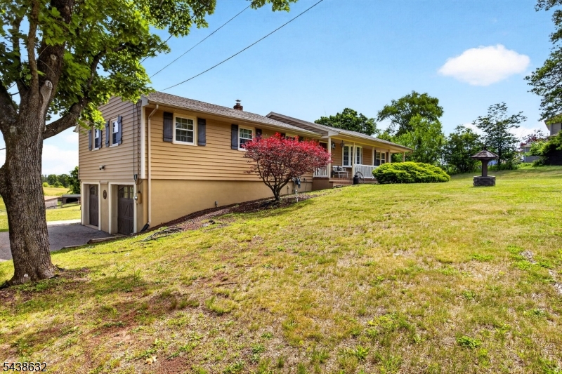 Surrounded by sweeping countryside views, this picturesque approx. 2.2-acre property in Branchburg Township offers the perfect blend of privacy, open space, and rural charm. This spacious 4-bedroom, 2-bath raised ranch is perfectly positioned to capture scenic views from nearly every angle. Inside, you'll find hardwood and vinyl flooring throughout much of the home, a generously sized formal dining room ideal for entertaining, an inviting family room anchored by a stunning brick fireplace, and a finished lower level offering flexible living space. The kitchen is complemented by a separate dining area where large sliding glass doors frame beautiful views of the property and provide access to the expansive deck. The primary bedroom features its own private en-suite bath. Step outside to enjoy the inground pool, fenced pasture areas, barn, and open acreage ideal for horses, hobby farming, or simply embracing the peaceful country lifestyle. A rare opportunity to enjoy country living with convenient access to shopping, dining, and major commuter routes. Seller is actively searching for a replacement property. Any accepted contract must provide a closing date that coincides with the seller's successful purchase and closing of a replacement home.Square footage per property tax records.