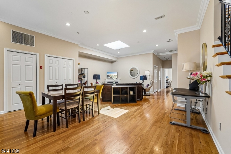 Welcome home to this open-concept floor plan which features 9-foot ceilings, hardwood floors, skylights, and oversized windows. This unit has both eastern and western exposures, filling the home with natural light from dawn to dusk. Generous living/dining areas create an inviting space for the modern lifestyle.   The working gas fireplace, and large granite island in the kitchen, are perfect places for gathering and entertaining. Conveniently found in one of Hoboken's best quiet locations, it is situated on the 4th floor of this elevator building. This spacious condo offers comfort, style, and accessibility, just moments from both the PATH train and Light Rail stations. The large primary suite offers privacy, while 2 additional bedrooms provide flexibility for guests, a home office, or changing lifestyle needs. Custom designer closets and abundant storage are found throughout. The hall bath features a jetted soaking tub, perfect for relaxing any time. Additional highlights include in-home laundry and a DEEDED parking space. A rare offering in Hoboken, this home also includes a PRIVATE deeded rooftop deck, approximately 12' x 13', with stunning Manhattan skyline views. Whether hosting al fresco dinners, enjoying morning coffee, practicing yoga, or chillin' beneath the city lights, this exclusive outdoor space provides the perfect extension of your home. Combining space, light, convenience, and exceptional outdoor living, this residence offers the very best of Hoboken living.