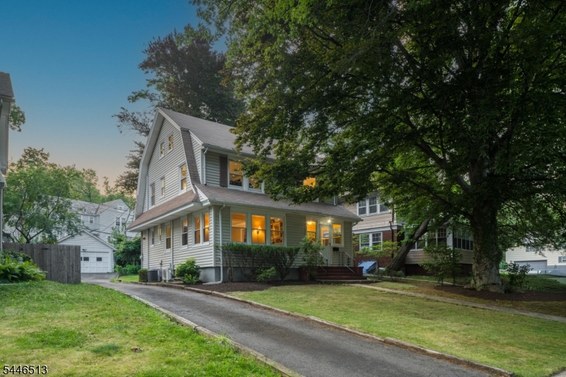 CHARMING 5-BED/2.1 BATH DUTCH COLONIAL IN VIBRANT SOUTH ORANGE PUTS YOU IN THE CENTER OF CULTURE, RECREATION, SCHOOLS & EASY BREEZY COMMUTING! This pretty & bright home features historic details like wide moldings, hardwood floors & built-ins, offering enough space & light to suit your daily needs. Highlights of the First Level include an enclosed Foyer/Entryway with easy-care tile floor, a large Living Room with decorative mantle, & a cozy Sun Room with a wall of built-in shelves & windows on two sides. Imagine curling up here with a good book! The Formal Dining Room nicely accommodates meals & the well-equipped Kitchen features gray-painted cabinetry, a gas range & space for a breakfast table or prep island. A Powder Room completes this floor. Second Level features four corner bedrooms ? with the Primary including two closets ? & a fully tiled, easy-to-clean Hall Bath with a tub/shower combo. Versatile Third Level offers a guest Bedroom, studio, or maybe just a private retreat with an attached Full Bath featuring a vintage clawfoot tub perfect for ?me? time. Lower Level is partially finished with Rec Room, Laundry Room & plenty of storage space. Level & private backyard with a wide detached Garage offering storage for a car, bikes, yard tools & more. Location cannot be beat! Just blocks to all schools, beloved community pool & park, NYC train, & lively downtown full of cultural events, local shops & great restaurants!