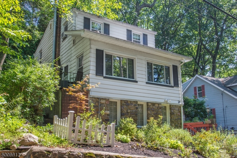 Commuter location!! Charming home situated in the desirable Indian Lake community just minutes from beach, boating, Clubhouse activities & more. Tons of Versatile Living Space! 1st floor offers open layout  stunning stone fireplace stands proudly in the oversized living area. Galley kitchen conveniently located off back patio & deck for BBQs, relaxation & entertaining. Full, walk-out BSMT w/baseboard heating, laundry & sink. Upstairs, 3 generous sized bdrms. Plenty of storage in bsmt & attic! You will love the yard w/level space & mature trees that provide fantastic shade & privacy. Just mins to DWTN Denville -a vibrant town w/shopping, farmers markets, restaurants, NYC bus & lovely music that plays while you stroll down Broadway! Easy access to major hwys & of course coffee shops for your morning commute.