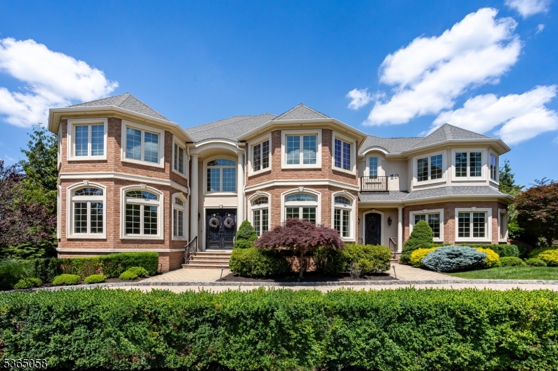 Luxury, space, and resort-style living await in this custom 6-bed, 6.1-bath estate on a quiet cul-de-sac in the coveted Bel Air Woods section of Livingston. Built in 2012 with over 6,300 sq ft, this home offers 10-ft ceilings, a chef's kitchen with top-tier Sub-Zero, Wolf, and Miele appliances, and a dramatic family room with a 20-ft ceiling, fireplace, and custom bar with additional Subzero appliances. Upstairs, the lavish primary suite features a gas fireplace and radiant heated bathroom floors, which extend to all second-floor bathrooms, the foyer, and the mudroom. A full laundry room is conveniently located on the second level. All bedrooms are en-suite, including one on the main level and a guest suite in the walk-out basement, which also features a home theater, gym, rec room, wet bar, and a 2,000-bottle temperature-controlled wine cellar. The finished walk-up attic adds bonus rec space with custom-built-ins. Enjoy radiant heat in all upstairs baths, Lutron lighting, multi-zone HVAC, a 3-car garage with EV charger, and underground utilities. The backyard is a private retreat featuring a heated saltwater pool and spa, outdoor kitchen, covered patio with electric screens, fire pit, and a custom shed. Located near top-rated schools, shopping, and NYC transit, this home is a rare find!