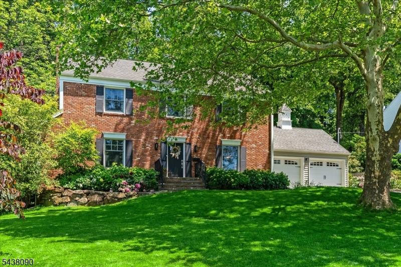 Welcome home to this beautifully updated 4 bedroom, 2.1 bath Colonial, perfectly situated on nearly 0.3 acres in one of Berkeley Heights' most sought-after neighborhoods. Open flow designed for the way we live today. The heart of the home is the bright, open-concept eat-in kitchen and family room. With a large center island, plenty of counter space, and a breakfast area, the kitchen is designed for both daily life and easy entertaining. The banquet-sized dining room and generous living room offer plenty of space to gather. Practicality meets style on the first floor with a dedicated mudroom, a convenient laundry room, and direct access to the two-car attached garage. Upstairs, the primary suite serves as a true retreat, complete with a spacious walk-in closet and a private en-suite bath. 3 additional bright bedrooms and a full hallway bath provide ample space for everyone. The lower level adds even more versatility with a finished recreation room perfect for movie nights or a home gym, plus plenty of storage in the utility room and crawl space. Outside, the lush backyard features a stunning patio designed for al-fresco dining and summer entertaining. With its thoughtful updates and prime location, this home is truly move-in ready. Located in a sought-after neighborhood known for its sense of community, this home is truly move-in ready, offering the added benefit of being just minutes away from premier local shopping and major highways for an effortless commute.