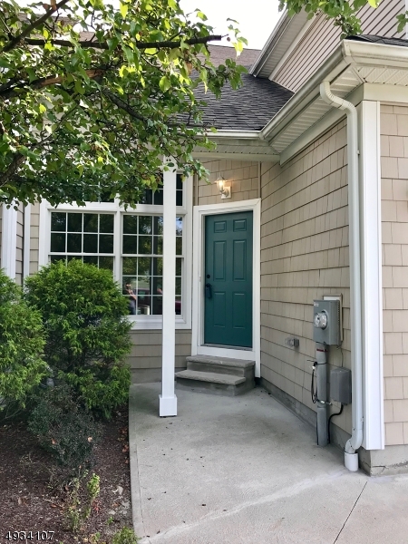 1st fl features master suite with walk-in shower, double vanity, walk-in & double closets, gorgeous kitchen w/center island, granite counters,stainless GE appliances, living rm, dining/ family room with 18' +-vaulted ceilings, laundry and powder room, luxury vinyl plank flooring, garage w/extra storage. 2nd floor has 2 bedrooms w/walk-in closets, den,second laundry room w/ placement for a kitchenette w/gas line, and full bath.  Walk-out basement to patio. Mountain views to High Point. Natural gas utilities. HOA fees include water, sewer, snow removal of your driveway and sidewalks, common area maintenance.