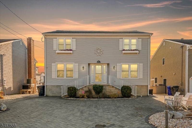 Nestled in coveted Mantoloking, this 5bed, 2.5bath lagoon front retreat has it all. The charming paver driveway sets the tone for everything this home has to offer. Step inside to a bright, open-concept living & dining area designed for easy coastal entertaining. Whether you're hosting a summer gathering or a quiet evening in, the flowing layout keeps everyone connected. Outside, the enclosed deck invites you to soak in the tranquil lagoon views, every moment here feels like a getaway. Rinse off after a day on the water with the outdoor shower. With direct access to Barnegat Bay, bring your boat, jet skis, or simply cast a line. And when the ocean calls, you're just a short stroll to the beach. Opportunities like 308 Cove Dr don't come along often, don't miss your chance to make it yours.