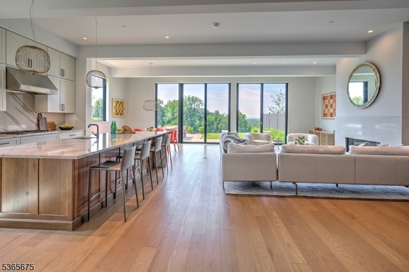 A rare opportunity to own one of only 12 Estate Residences at Pendry Natirar, a private gated enclave in the Somerset Hills just 45 miles from NYC. This 4-level, 12-room townhouse offers over 5,500 sq ft of refined living space with stunning views, blending the comforts of a private home with the luxury services of the premier Pendry Natirar Hotel. Features include 11' ceilings on the main level, wide plank oak and porcelain tile flooring, Pella floor-to-ceiling windows, custom blinds throughout, designer appliances, quartz countertops, elevator access to 3 levels, custom California closets, and smart home pre-wiring. Enjoy panoramic views from two expansive terraces and a low-maintenance exterior with Nichiha siding and cultured stone. Mutli-zone heating and cooling, generator and the finished lower level is plumbed for a full bath. Residents, enjoy access to the exclusive Natirar Club (membership required), Spa Pendry, fitness center, tennis courts, pools, hiking trails, and curated lifestyle programming. Dining options include Ladd's Tavern at the 66-room Pendry Hotel and the acclaimed Ninety Acres Restaurant & Cooking School. Surrounded by 500 acres of natural beauty and an 8-acre sustainable farm, 51 Abby Rd offers resort-style living in a setting focused on wellness, sustainability, and understated elegance.