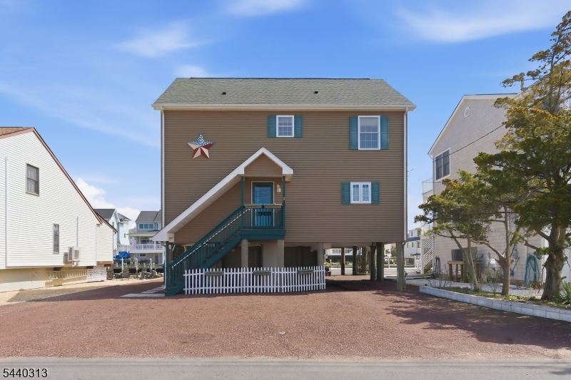 All about the Views, this 2,419 Sq Ft Home offers 3 Bed & 2.5 Bath, just 11 Year Young Raised Home (All New After Sandy) with 60 Ft of Vinyl Bulkhead. Immaculately kept Bright & Airy Boasting an Open Floor Plan, great for entertaining. Step out onto the Screened In Porch and Deck (Gas Hook up for the Grill) to take in the Views of Forked River. The Eat-In Kitchen w Custom Cabinets, Grante Counters, SS Appliances, 2 Large Sliders off the Living and Dining Room. Also a LG Half Bath completes the 1st Fl. The 2Nd Fl Houses the 3 Bedrooms, Guest Bath, Laundry Closet and Master Bedroom w WI Closet, Master Bath has 2 Sinks, Jacuzzi Tub, Shower, Heated Towel Rack & Private Balcony For the morning coffee or evening wine.. Additional Features are a walk up Finished Attic whichcan be heated for additional Living Space. There's also a Car Port & Lg Shed built under the house for added Storage. Minutes to the Bay plus Quick Access to Dock & Dine Restaurants, Full-service Marinas, Tices Shoal & Inlet!