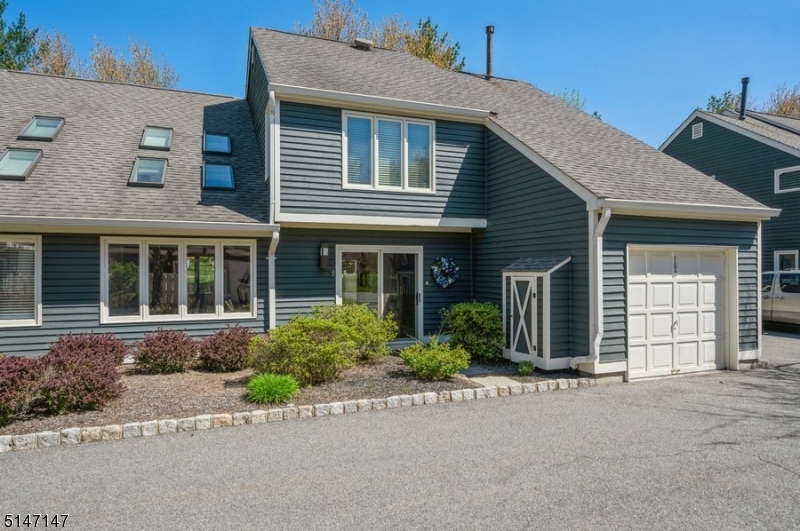 Spacious Townhome in an Idyllic Location! The main level of this lovely 3B 2 1/2BTH home features gleaming hardwood floors, high ceilings & bright sun-filled spaces. A gorgeous updated eat-in kitchen offers ample white cabinetry, recessed lighting, backsplash, SS appliances & a gracious breakfast area set in front of sliding glass doors to a private, fenced stone patio where you can grill on the BBQ (included w/gas connection) or enjoy a cup of morning coffee. The adjacent DR has chair rail molding detail, as well as direct flow into the oversized LR featuring a vaulted ceiling with 2 skylights for plenty of natural light, as well sliding glass doors that lead to the rear of the property. Off the foyer is a cozy FR w/corner wood-burning fireplace. A discreet powder room, main floor laundry w/new washer & dryer and garage access complete this level. Upstairs, you'll find the primary suite overlooking the LR below, a large walk-in closet & en-suite bath w/dual vanity & separate jetted tub & shower. 2 additional BD, including one w/access to a large storage space housing the home's utilities & a full BTH of the hall. This landscaped property is located in Lord Stirling Village, a community surrounded by protected green areas for a peaceful setting, w/amenities that include an in-ground pool & tennis courts. This unit includes an attached 1-car garage as well as additional parking &you're conveniently close to multiple parks, shopping, restaurants, and transit options.