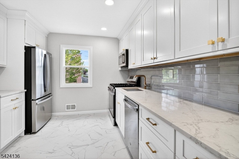 Welcome to this beautifully updated 3 bedroom, 1.5 bath home located in highly sought-after Fanwood. This move-in ready property features gleaming hardwood floors throughout the first level, a fully renovated modern kitchen with stylish finishes, and tastefully updated bathrooms that truly shine. The lower level offers a flexible space that can be used as a family room, rec room, or whatever you wish! This space has modern laminate floors and a half bath for convenience. The backyard is perfect for entertaining with a covered patio and plenty of grass to enjoy. The spacious layout offers comfort and versatility, perfect for today's lifestyle. Ideally situated just a stone's throw from the train and downtown area, this home offers exceptional convenience for commuters. Enjoy close proximity to local parks, as well as easy access to major highways and nearby bus routes. Located in a top-rated Blue Ribbon school district, this property combines location, lifestyle, and quality living in one outstanding opportunity. Don't miss your chance to be in a great spot in Fanwood! Fanwood has a A+ rating by Niche, who ranked it the #1 town to live in Union County and #3 in New Jersey!