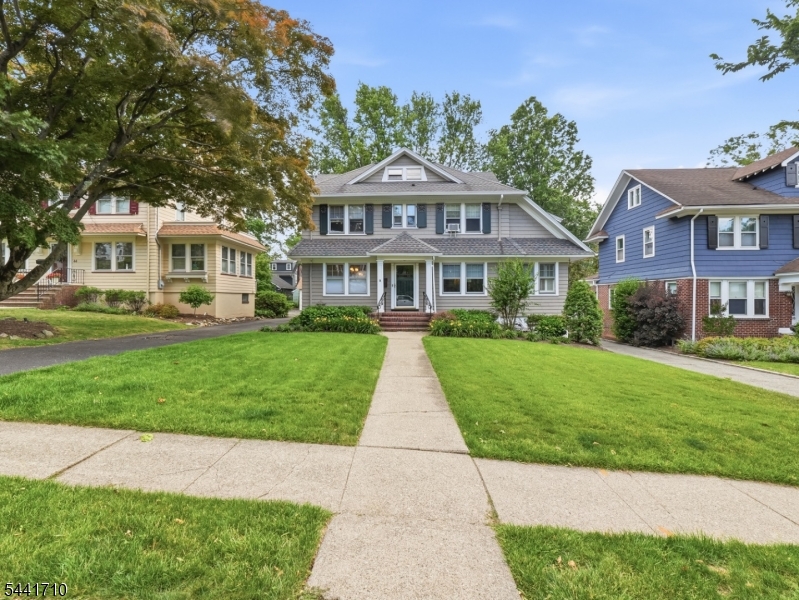 Welcome home to this stunning 4-bedroom, 3.5-bathroom Colonial gem nestled on one of Maplewood's most sought-after streets. Boasting 2,600 square feet of beautifully designed, functional living space across four finished levels, this 1920s classic perfectly blends historic character with modern updates. The inviting first floor features a formal dining room and an expansive living room centered around a cozy wood-burning fireplace ideal for winter gatherings. The chef's kitchen is equipped with stainless steel appliances and features seamless slider access to a private outdoor deck. Unwind in the adjoining screened-in porch, which overlooks a lush, level backyard perfect for outdoor dining and play.The upper levels offer four generous bedrooms, including a primary suite with a walk-in closet and dressing area. Need a home office, gym, or playroom? The finished lower level adds incredible versatility with a large recreation room, a private workspace, laundry, and a dedicated workshop area. Outside, the property features a multi-car driveway leading to a convenient 2-car detached garage. Situated just minutes from the NYC midtown direct train, local parks, top-rated schools, and the vibrant Maplewood Village, this home truly has it all.